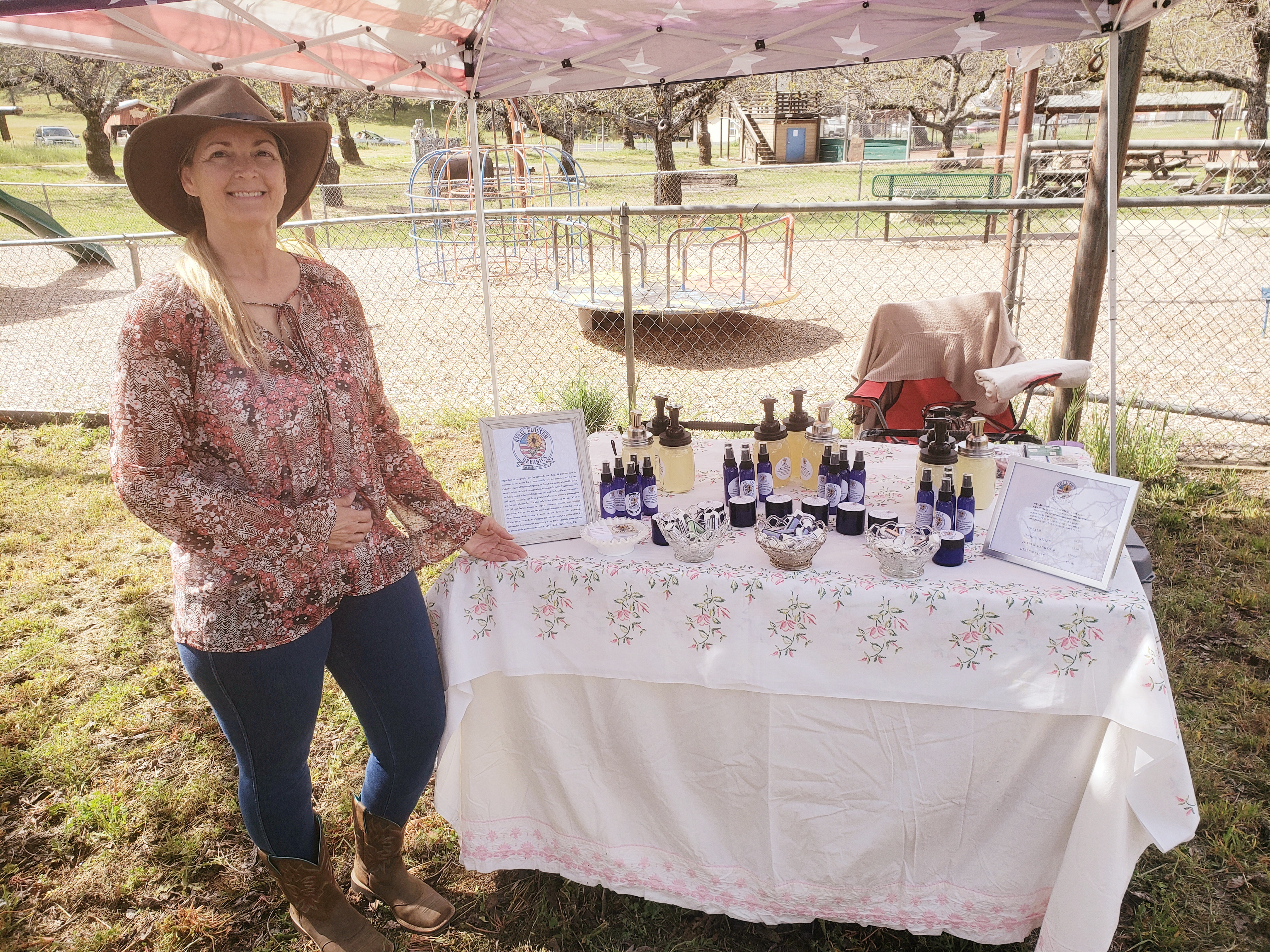 Owner next to table of products